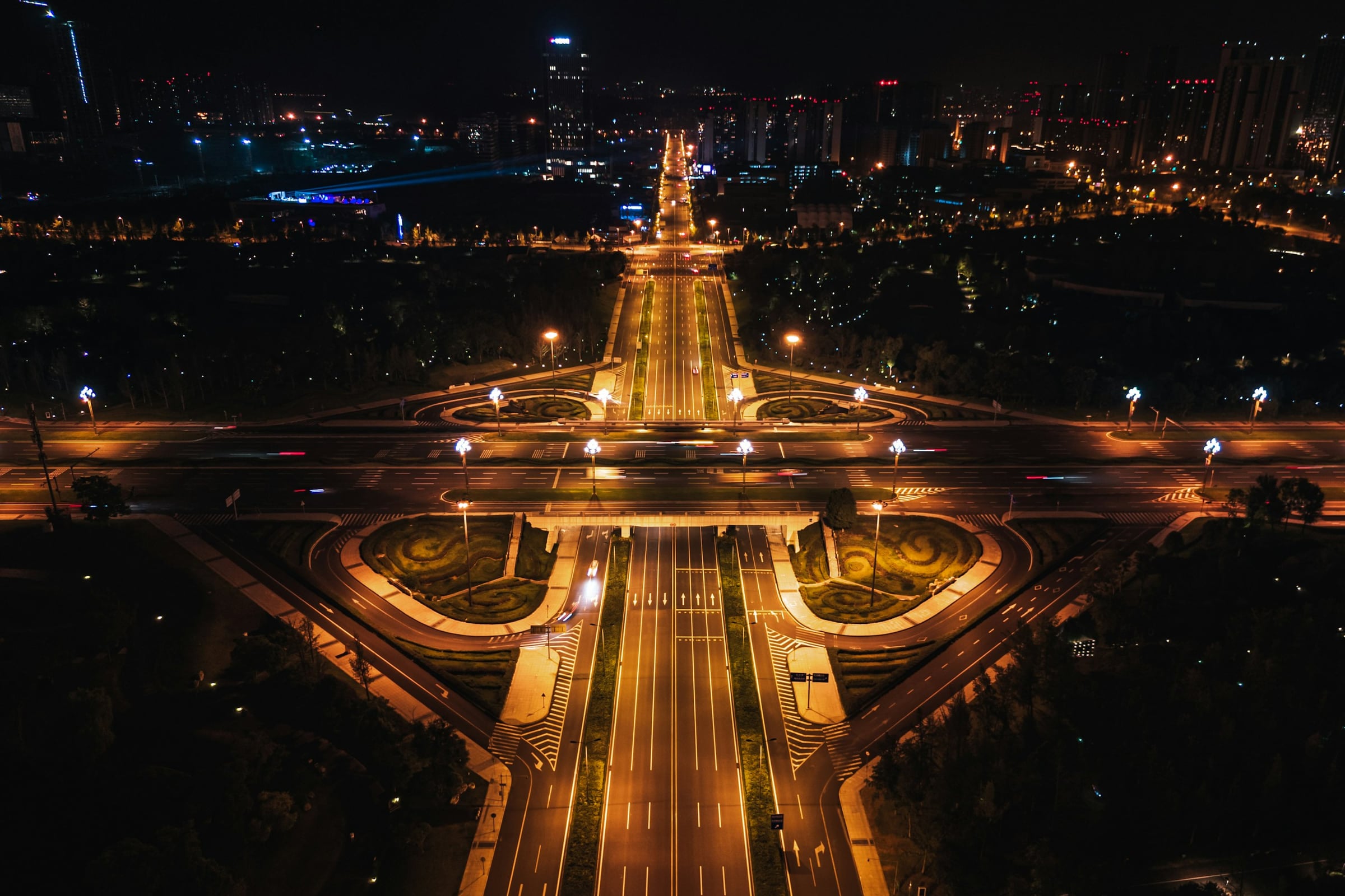 City boulevard and intersections lit up at night, seen from above